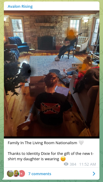 Photo of the family in living room (Ross Wainwright's face redacted by Amy Wainwright). Amy Wainwright notes that the Confederate flag t-shirt her daughter is wearing was provided by the white nationalist group Identity Dixie.
