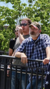 A close-up photo showing Michael Newidomy (in the sunglasses) standing next to Mitchell Rivers ("Wade Garrett"). 